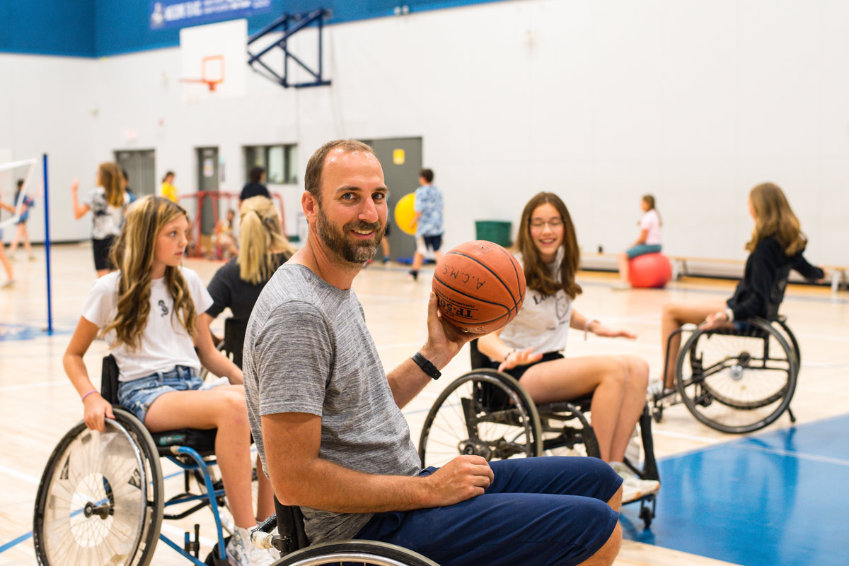 Kit Williams with a basketball in a wheelchair